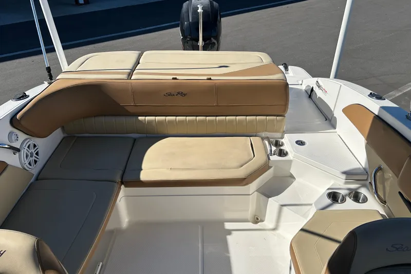 Slide: The Image of 2018 Sea Ray SPX 210 Outboard boat interior with tan seating and cup holders. - 12