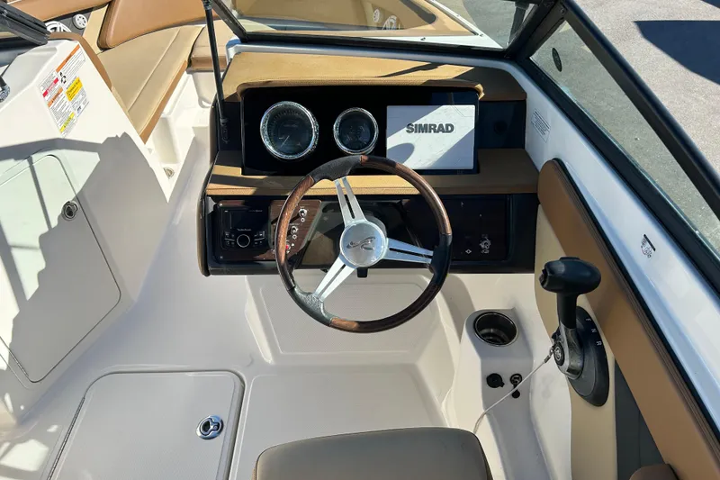 Slide: The Image of 2018 Sea Ray SPX 210 Outboard boat dashboard with steering wheel and Simrad display. - 13