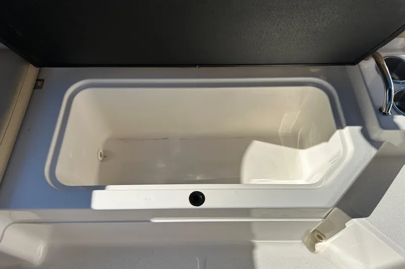 Slide: The Image of 2018 Sea Ray SPX 210 Outboard storage compartment, open and empty. - 16