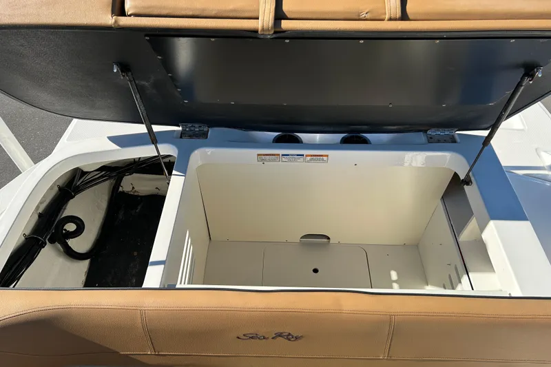 Slide: The Image of Open storage compartment on a 2018 Sea Ray SPX 210 Outboard boat. - 17