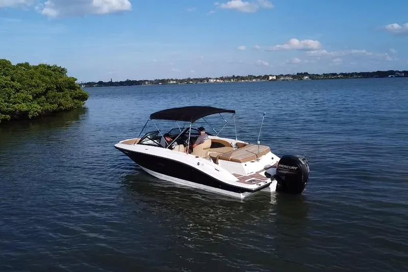 Slide: The Image of 2018 Sea Ray SPX 210 Outboard boat on calm water under blue sky. - 19