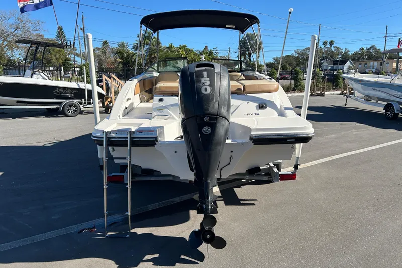Slide: The Image of 2018 Sea Ray SPX 210 Outboard boat with 150 HP engine, parked outdoors. - 3