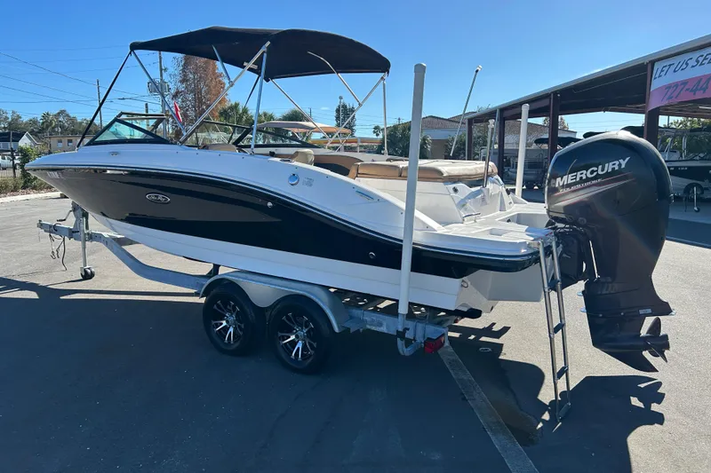 Slide: The Image of 2018 Sea Ray SPX 210 Outboard boat on trailer with Mercury engine, parked outdoors. - 4