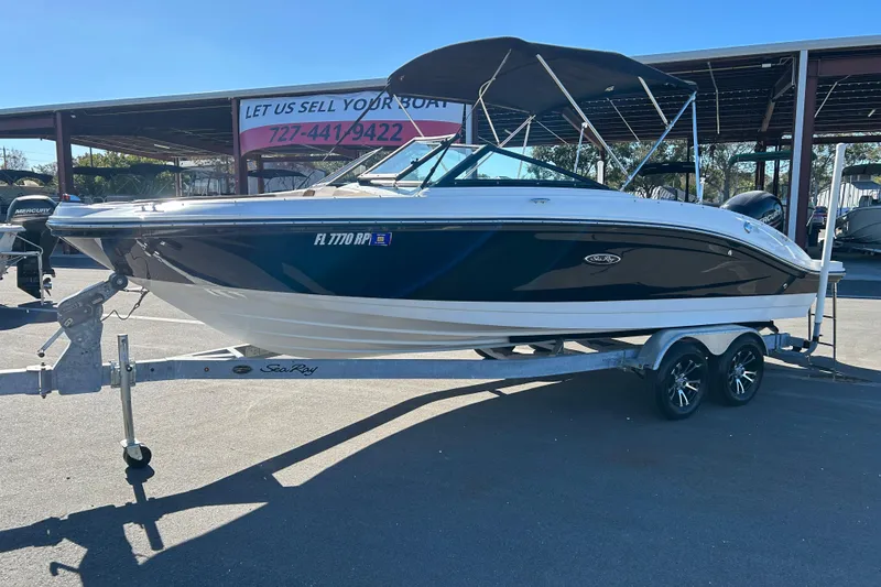 Slide: The Image of 2018 Sea Ray SPX 210 Outboard boat on trailer, parked outdoors. - 5