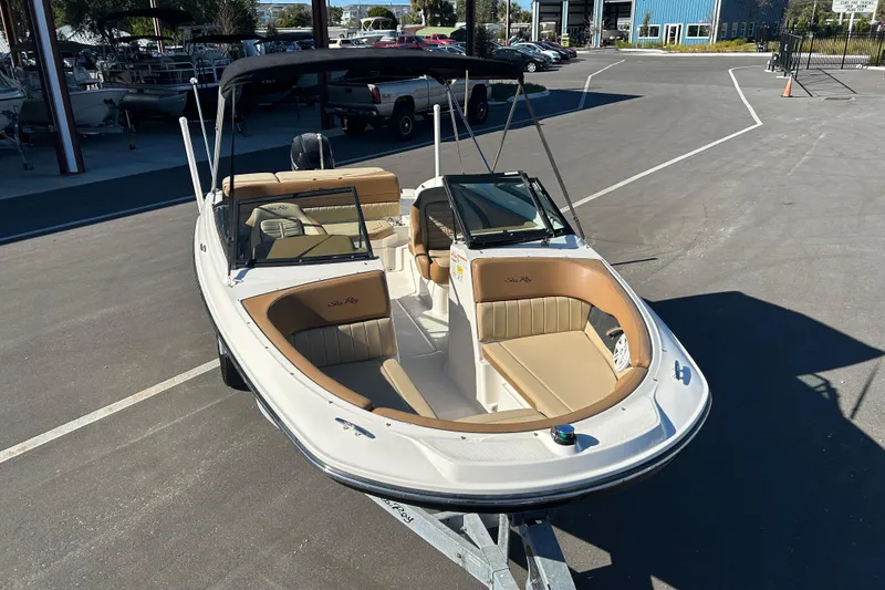 Slide: The Image of 2018 Sea Ray SPX 210 Outboard boat on trailer, parked in a marina lot. - 6