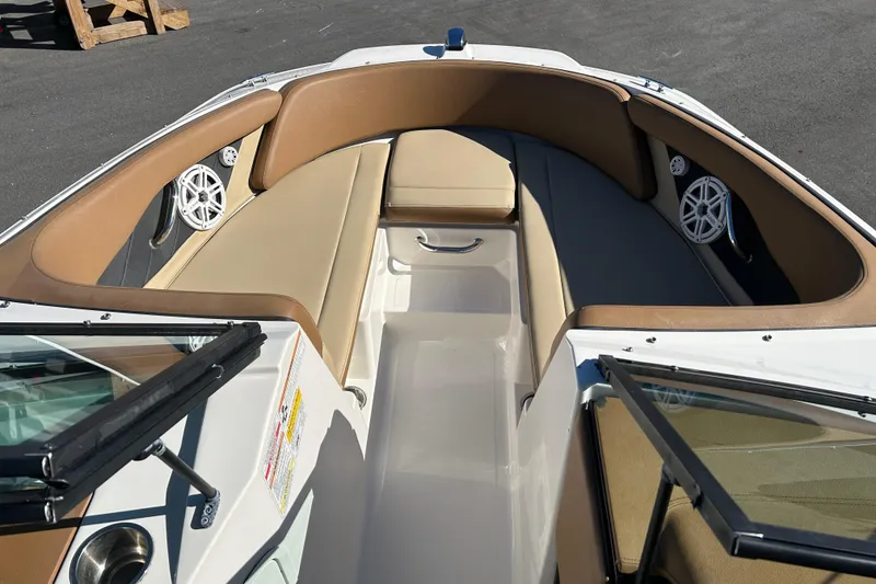 Slide: The Image of 2018 Sea Ray SPX 210 Outboard boat interior with tan seating and speakers. - 8