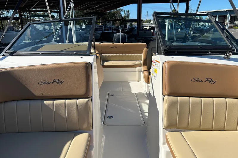 Slide: The Image of 2018 Sea Ray SPX 210 Outboard boat interior with tan seating and windshield. - 9