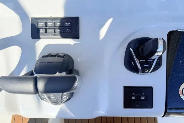 Slide: The Image of Control panel of 2026 Tidewater 302 CC Adventure boat with throttle and switches. - 11