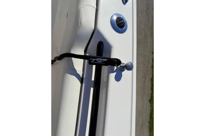 Slide: The Image of 2026 Tidewater 302 CC Adventure boat detail with cleat and rod holder. - 12