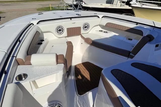 Slide: The Image of 2026 Tidewater 302 CC Adventure boat interior with cushioned seating and modern design. - 13