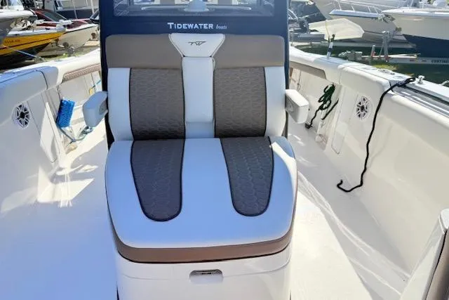 Slide: The Image of 2026 Tidewater 302 CC Adventure boat seat with stylish upholstery in a marina setting. - 14