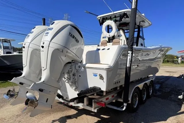 Slide: The Image of 2026 Tidewater 302 CC Adventure boat with twin Yamaha engines on a trailer. - 4