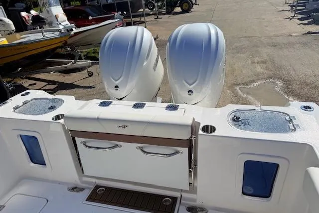 Slide: The Image of 2026 Tidewater 302 CC Adventure boat with dual engines, featuring a spacious deck layout. - 6