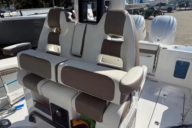 Slide: The Image of 2026 Tidewater 302 CC Adventure boat interior with cushioned seating and modern design. - 7