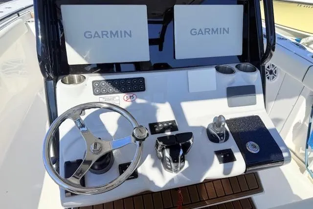 Slide: The Image of Helm of 2026 Tidewater 302 CC Adventure with dual Garmin displays and modern controls. - 9
