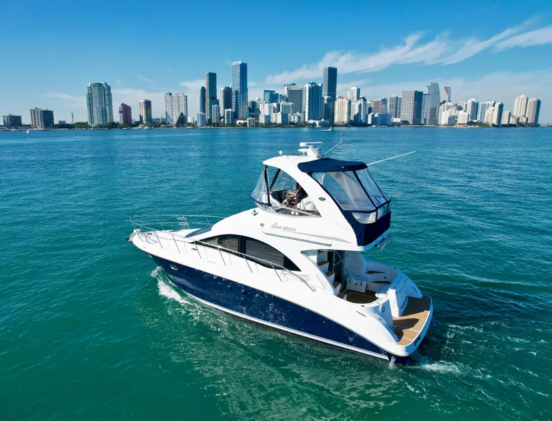 Slide: The Image of 2007 Sea Ray 360 Sedan Bridge yacht cruising near a city skyline. - 10