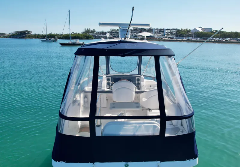 Slide: The Image of 2007 Sea Ray 360 Sedan Bridge on calm water, rear view with clear enclosure. - 11