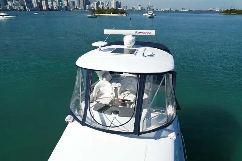 Slide: The Image of 2007 Sea Ray 360 Sedan Bridge yacht on clear water with city skyline. - 12