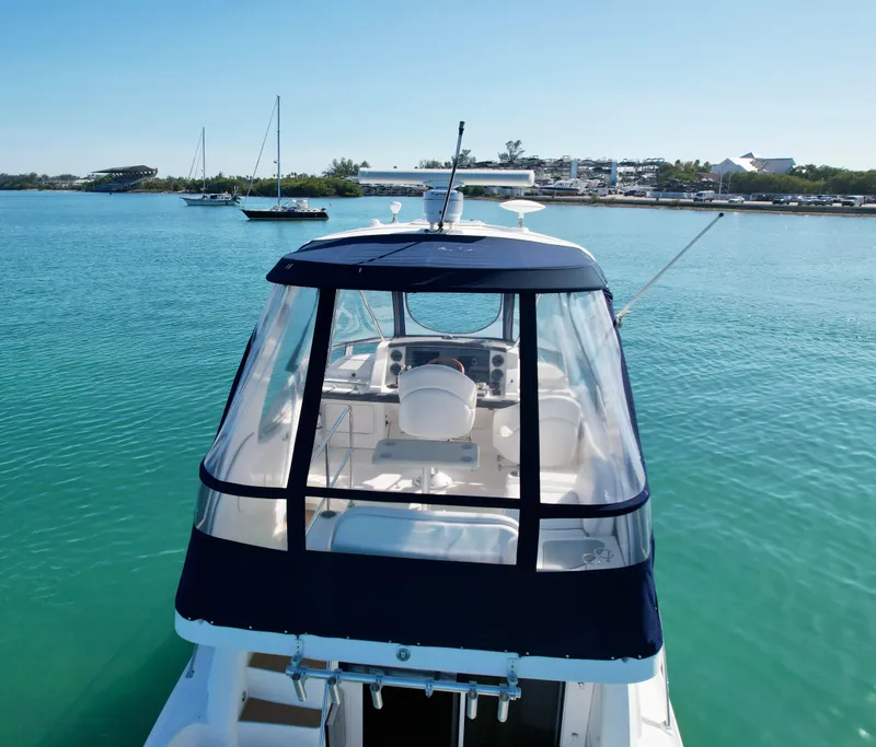 Slide: The Image of 2007 Sea Ray 360 Sedan Bridge yacht on clear blue water, featuring a covered helm. - 13
