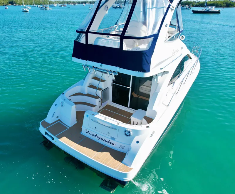 Slide: The Image of 2007 Sea Ray 360 Sedan Bridge yacht on clear turquoise water. - 16