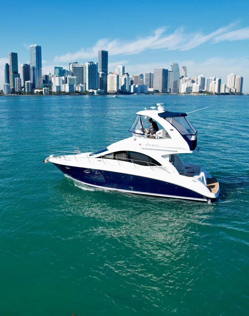 Slide: The Image of 2007 Sea Ray 360 Sedan Bridge yacht cruising near a city skyline. - 22