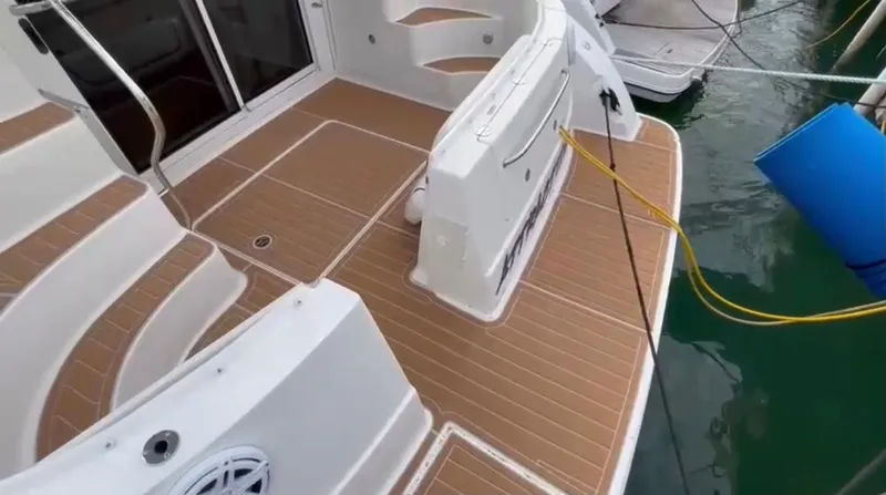 Slide: The Image of 2007 Sea Ray 360 Sedan Bridge boat deck with teak flooring and docked at marina. - 26