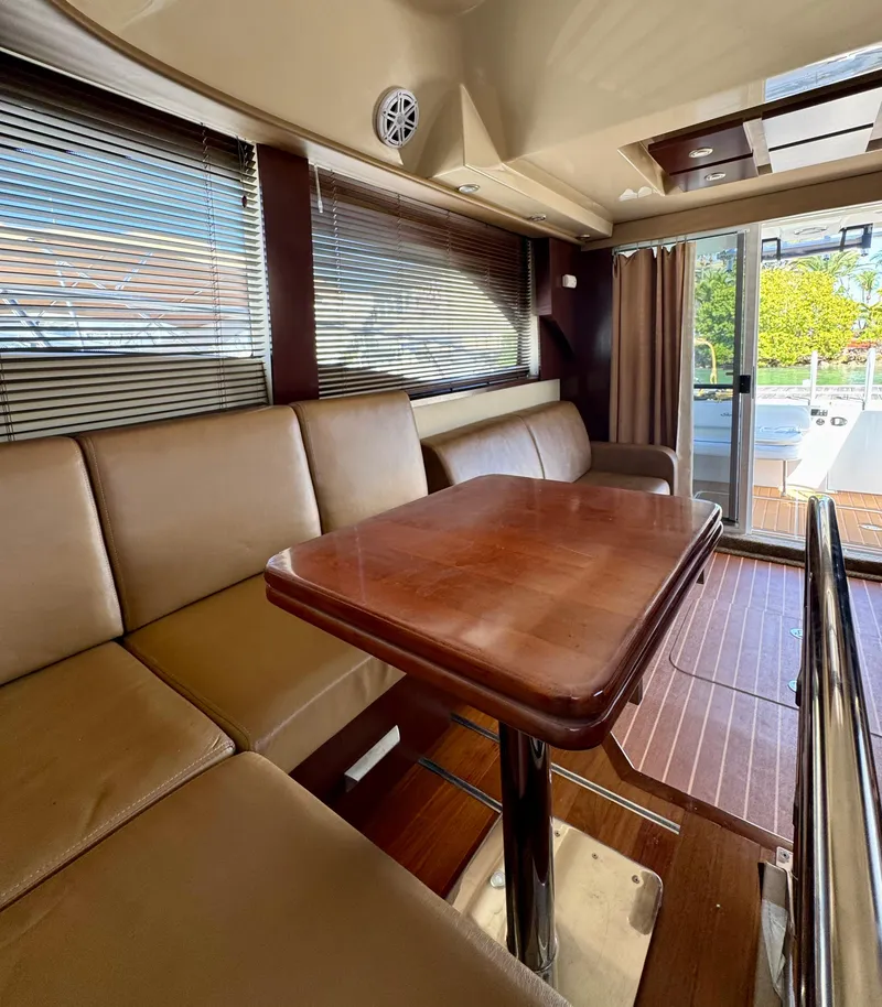 Slide: The Image of Interior of 2007 Sea Ray 360 Sedan Bridge with leather seating and wooden table. - 29