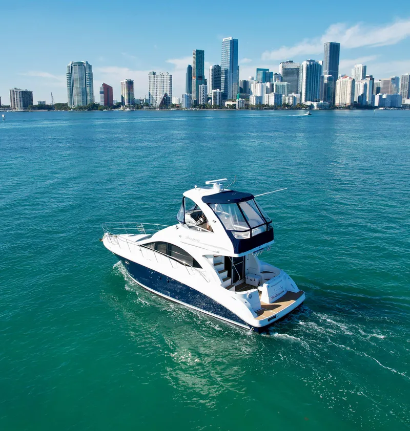 Slide: The Image of 2007 Sea Ray 360 Sedan Bridge yacht cruising near a city skyline. - 3