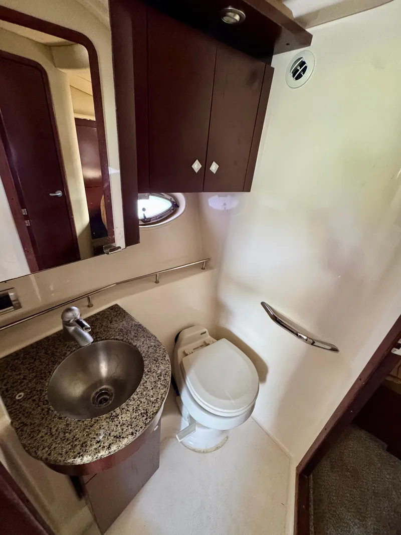Slide: The Image of 2007 Sea Ray 360 Sedan Bridge bathroom with sink, toilet, and storage cabinet. - 36