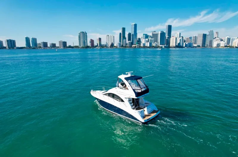 Slide: The Image of 2007 Sea Ray 360 Sedan Bridge yacht cruising near city skyline. - 8