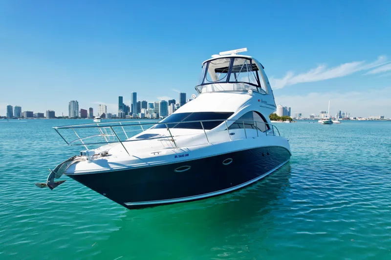 Slide: The Image of 2007 Sea Ray 360 Sedan Bridge yacht on clear water with city skyline. - 9