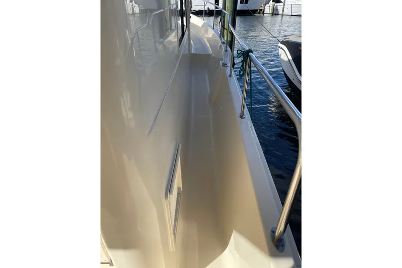 Slide: The Image of Interior of 2008 Mainship 34 Trawler Hardtop with blue sofa and helm station. - 11