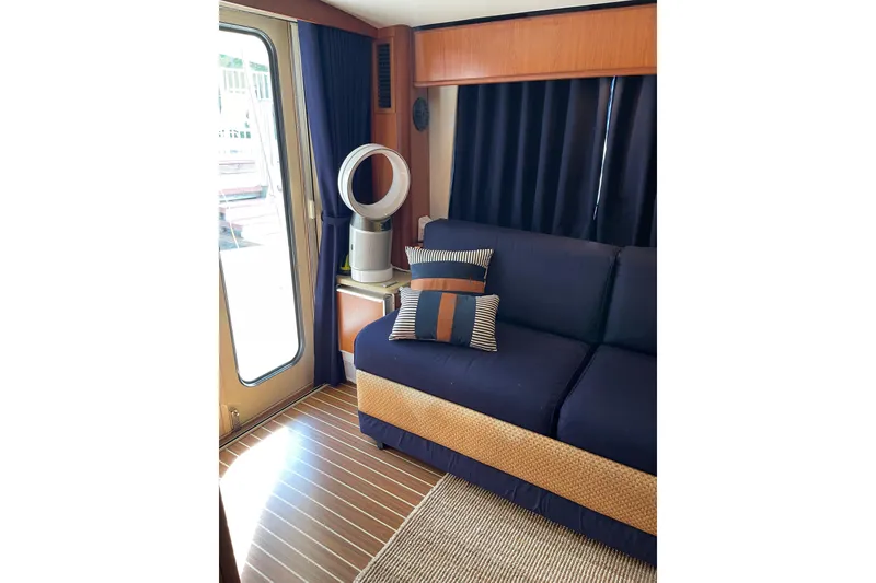 Slide: The Image of Interior of 2008 Mainship 34 Trawler Hardtop, featuring helm, seating, and panoramic windows. - 17