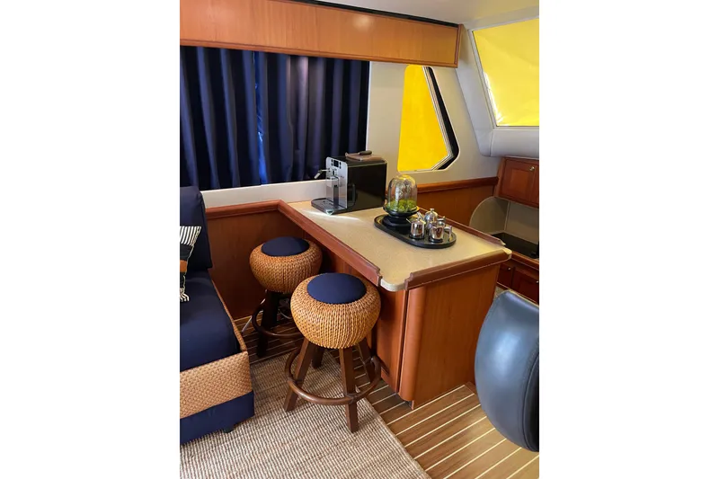 Slide: The Image of 2008 Mainship 34 Trawler Hardtop interior with cozy seating and nautical decor. - 18