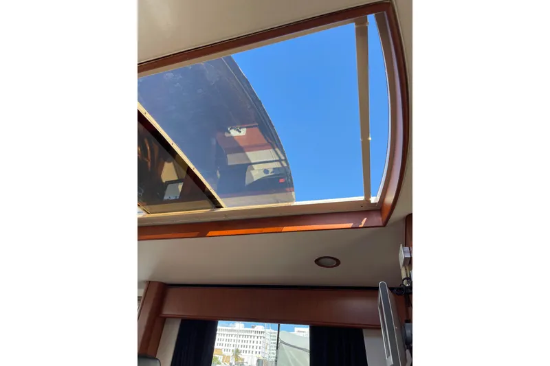 Slide: The Image of 2008 Mainship 34 Trawler Hardtop interior with kitchenette, featuring wood finish and modern appliances. - 24