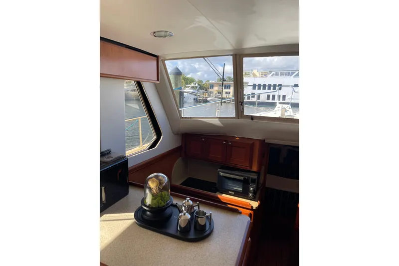 Slide: The Image of 2008 Mainship 34 Trawler Hardtop kitchen with open stainless steel drawer fridge. - 25