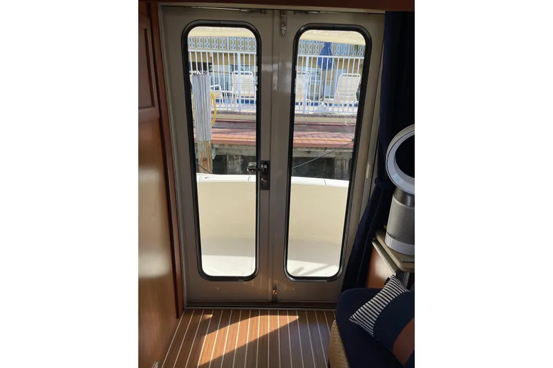 Slide: The Image of 2008 Mainship 34 Trawler Hardtop interior with wood cabinetry and cozy bedroom. - 27