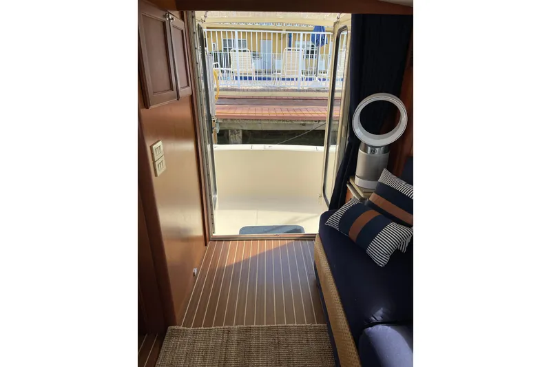 Slide: The Image of Cozy bedroom in 2008 Mainship 34 Trawler Hardtop with striped bedding and porthole windows. - 28