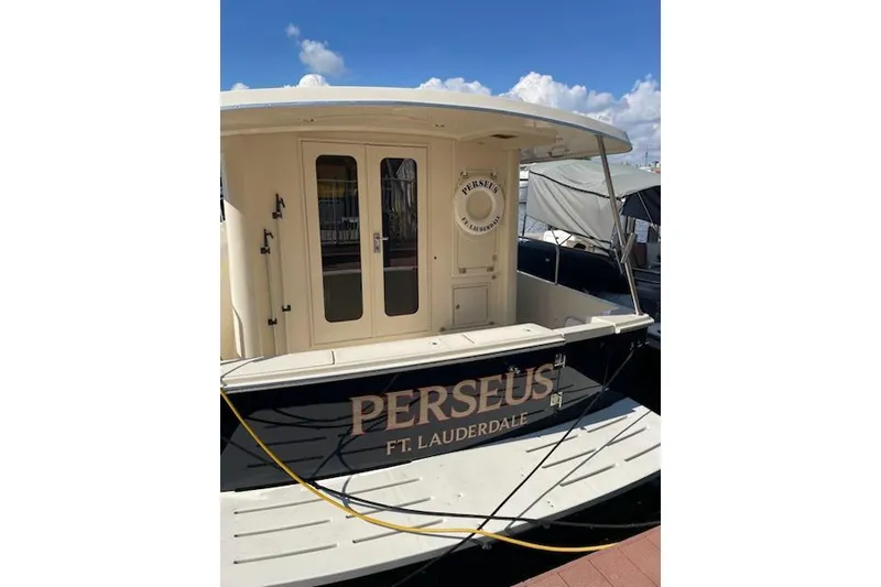 Slide: The Image of 2008 Mainship 34 Trawler Hardtop docked, featuring "Perseus" name and Fort Lauderdale location. - 3