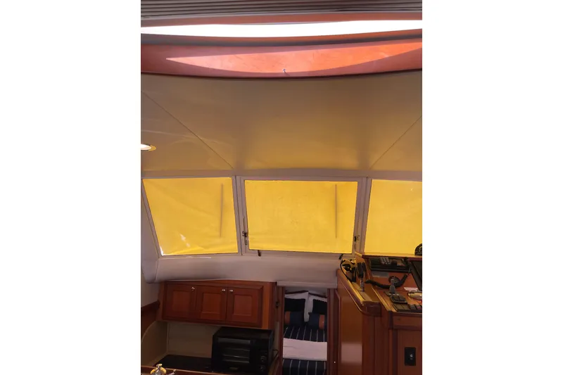 Slide: The Image of Bathroom interior of 2008 Mainship 34 Trawler Hardtop with sink, mirror, and porthole window. - 30