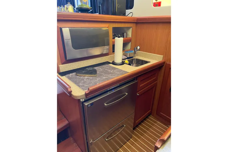 Slide: The Image of Engine room of 2008 Mainship 34 Trawler Hardtop with fire extinguisher and machinery. - 47