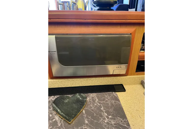 Slide: The Image of 2008 Mainship 34 Trawler Hardtop on dry dock, blue hull, red bottom, clear sky. - 51