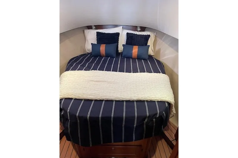 Slide: The Image of 2008 Mainship 34 Trawler Hardtop with blue hull and red bottom on stands. - 54