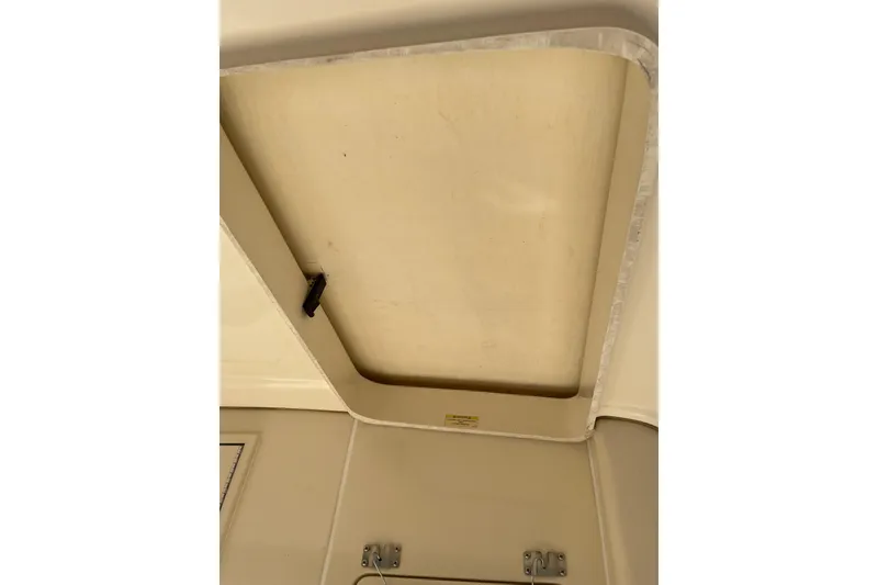 Slide: The Image of 2008 Mainship 34 Trawler Hardtop docked near a waterfront property with palm trees. - 7