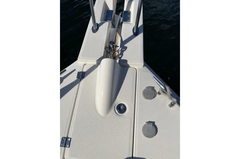 Slide: The Image of 2008 Mainship 34 Trawler Hardtop docked in a marina with blue sky. - 8