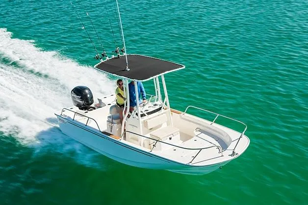 Slide: The Image of Manufacturer Provided Image: 2026 Boston Whaler 190 Montauk boat cruising on clear turquoise water. - 2