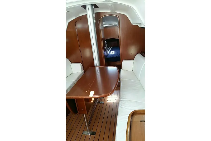 Slide: The Image of Cockpit of 2003 Beneteau First 36.7 sailboat with ropes and wooden table. - 12
