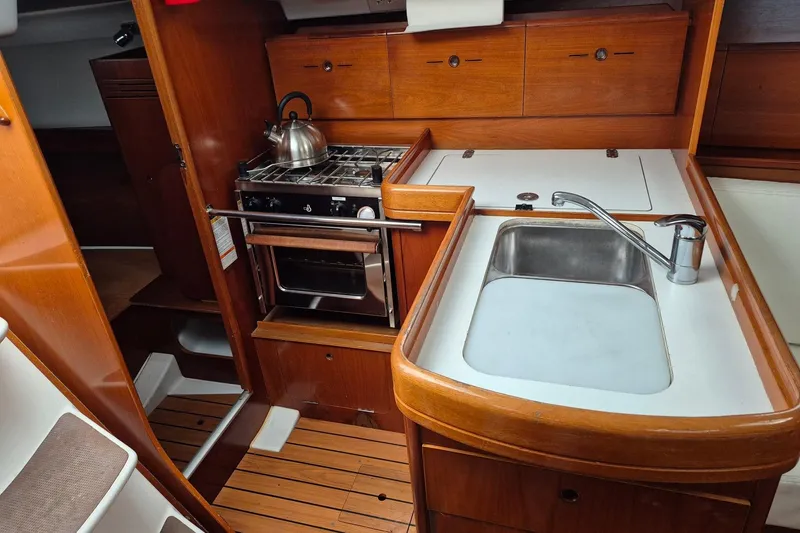 Slide: The Image of Interior of 2003 Beneteau First 36.7 yacht with white sofa and wooden cabinetry. - 16
