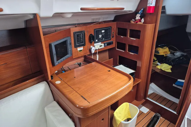 Slide: The Image of Interior of 2003 Beneteau First 36.7 yacht with wooden finish and white seating. - 18