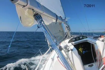 Slide: The Image of 2003 Beneteau First 36.7 sailing on open sea under clear blue sky. - 2